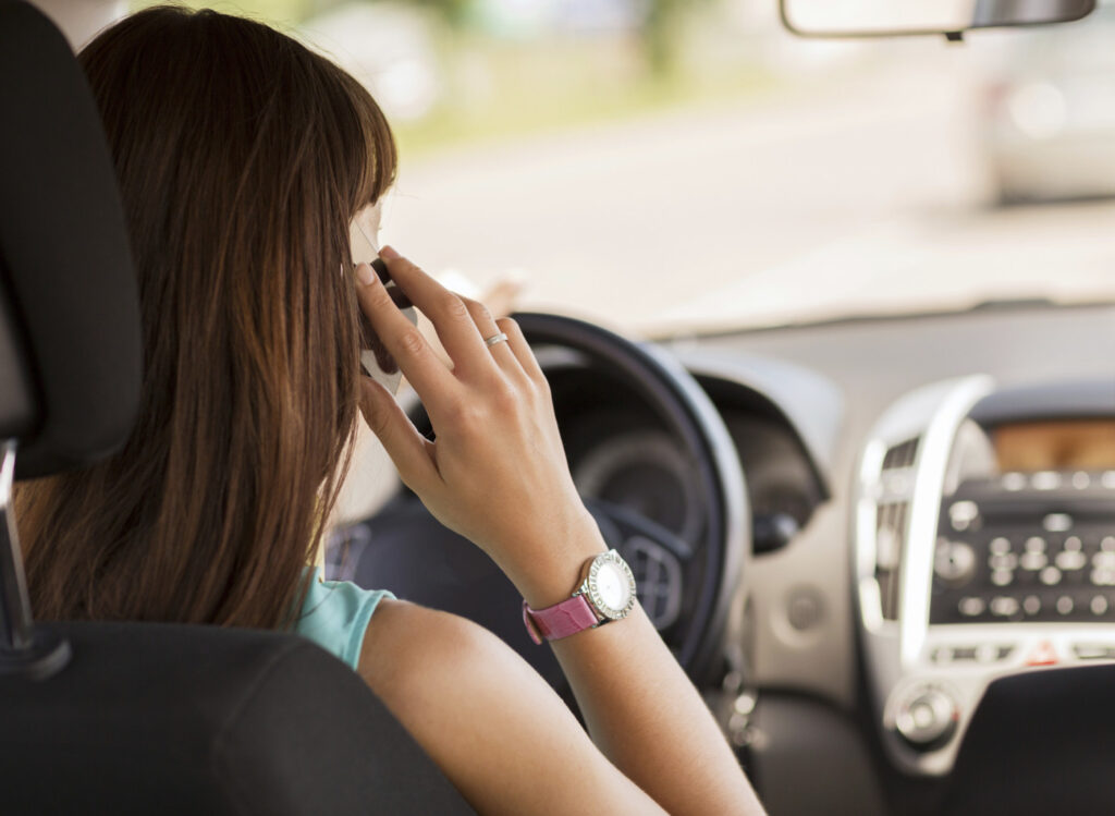 Rental car driver on phone.